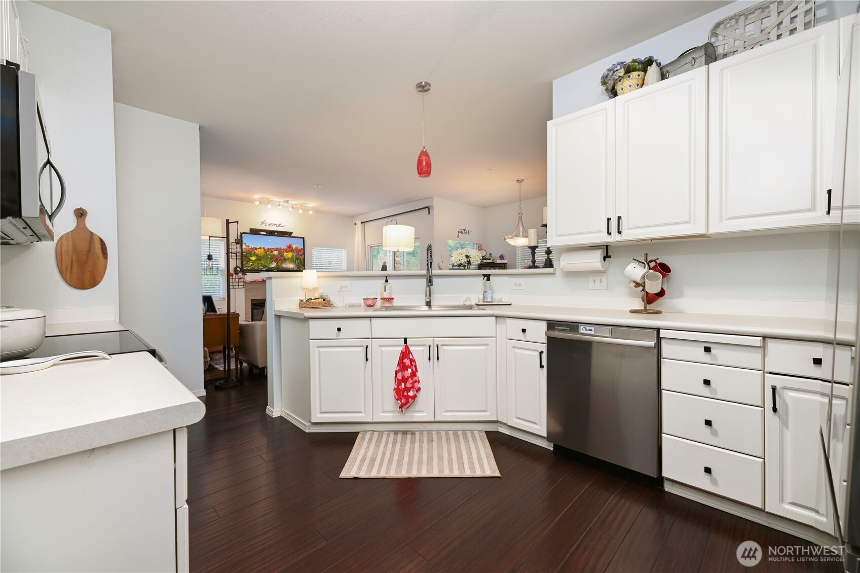 17761 134th Lane Southeast Renton, WA 98058 - Photo 13 of 38 a utility room with stainless steel appliances a white cabinets and wooden floor