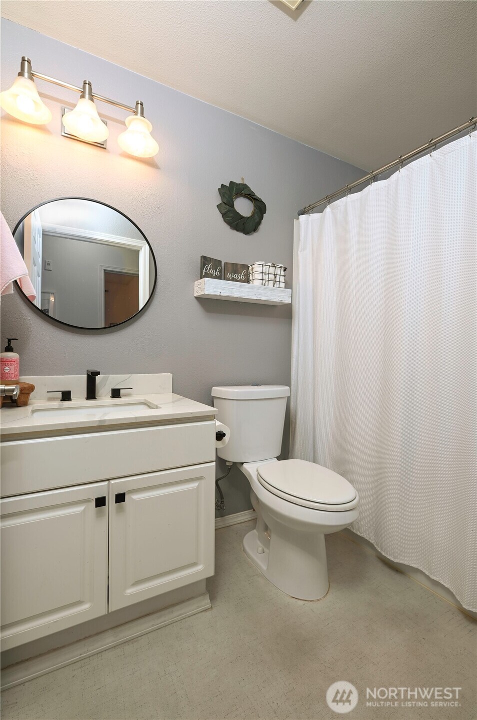 17761 134th Lane Southeast Renton, WA 98058 - Photo 18 of 38 a bathroom with a toilet sink and mirror