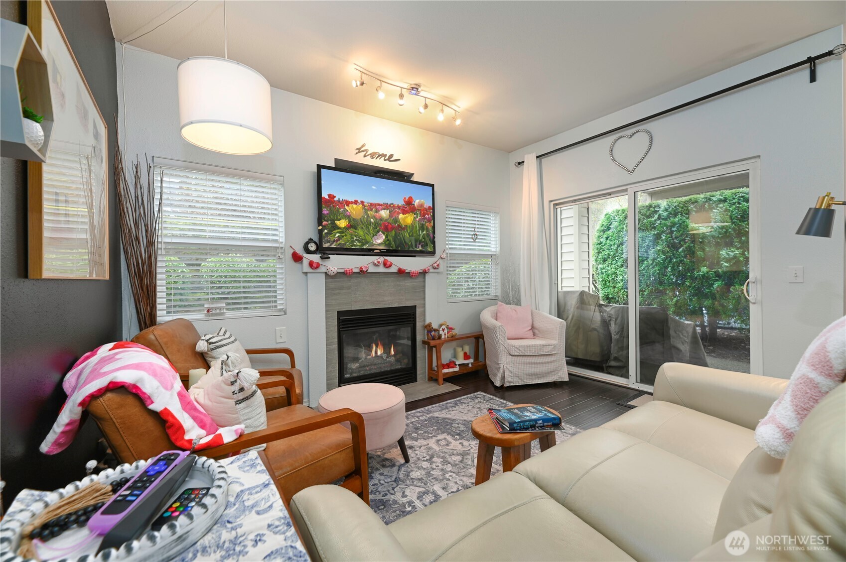 17761 134th Lane Southeast Renton, WA 98058 - Photo 8 of 38 a living room with furniture a fireplace and a flat screen tv