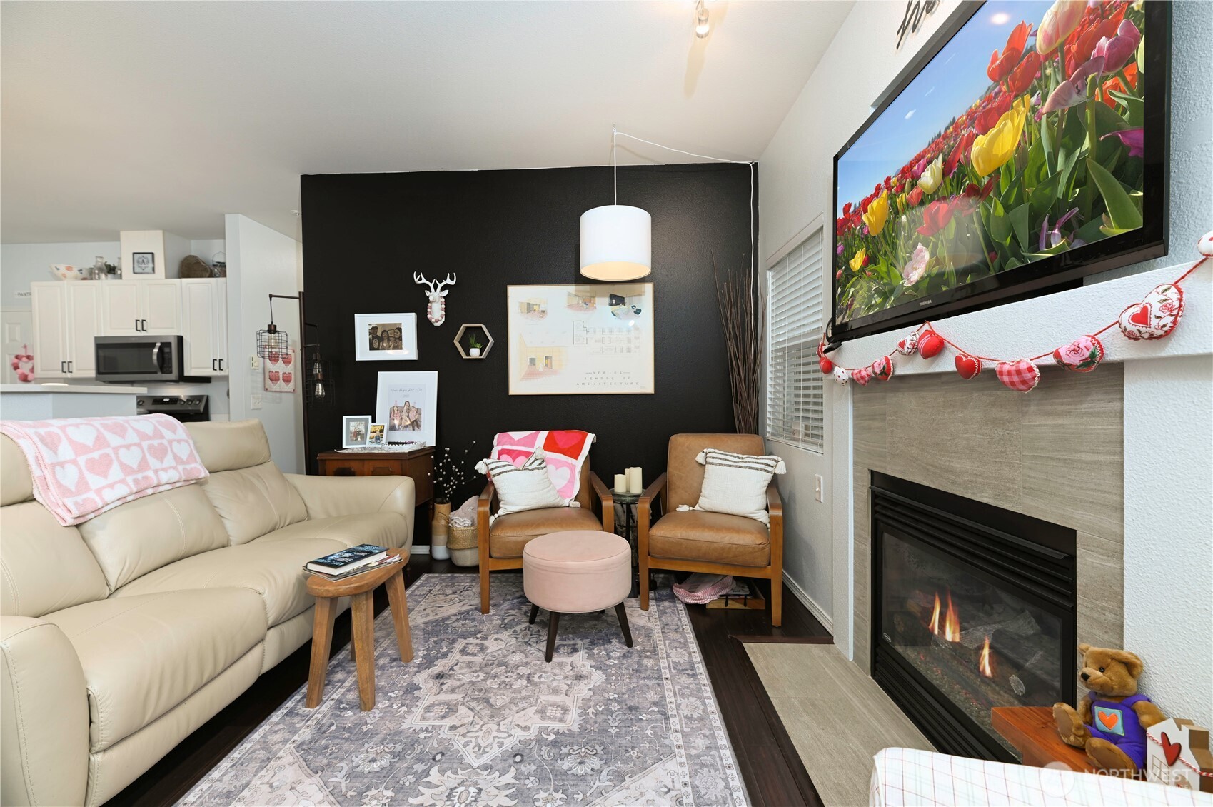 17761 134th Lane Southeast Renton, WA 98058 - Photo 10 of 38 a living room with furniture a flat screen tv and a fireplace