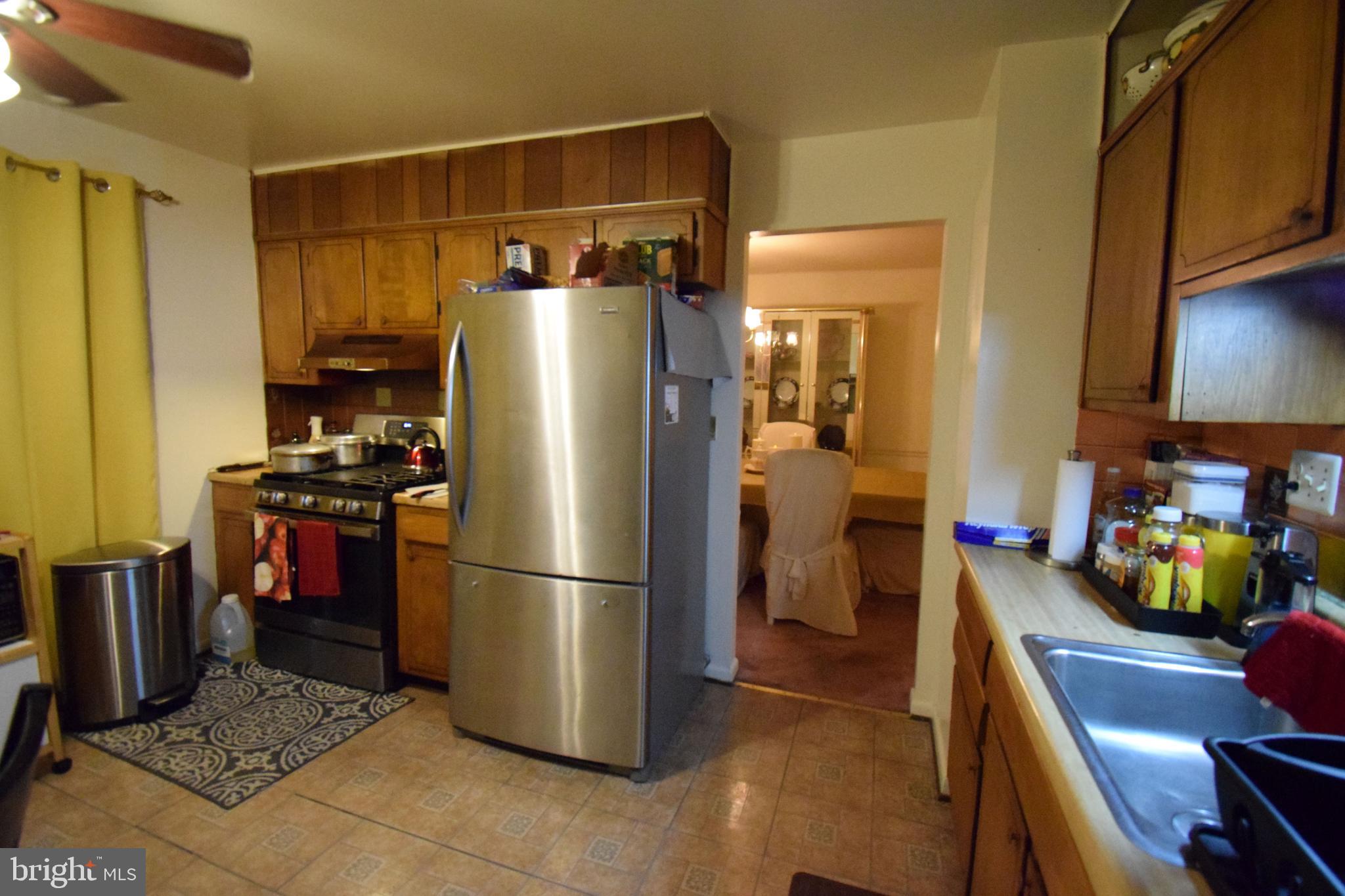 4605 Sharon Road Temple Hills, MD 20748 - Photo 16 of 19 a kitchen with a refrigerator wooden floor and a dining table