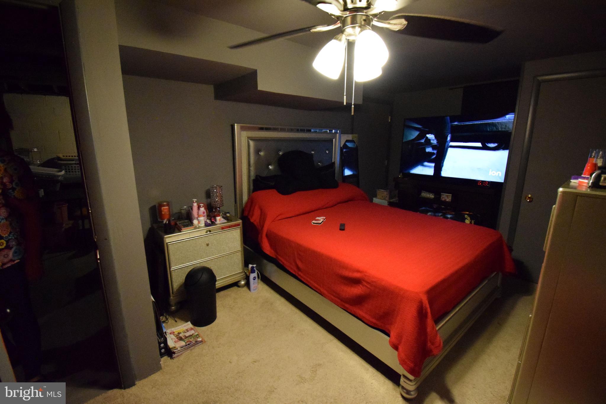 4605 Sharon Road Temple Hills, MD 20748 - Photo 19 of 19 a bed room with a bed and a chandelier