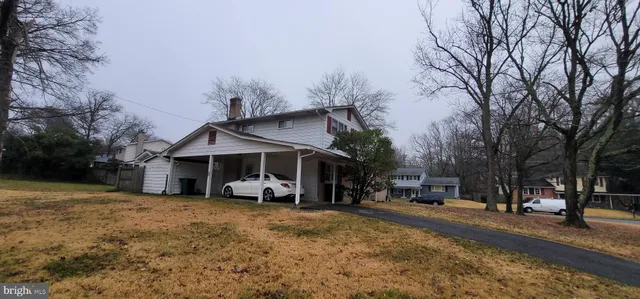 a view of a house with a snow on the road