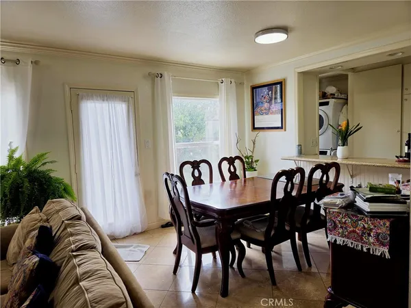 a view of a a dining room with furniture window and wooden floor