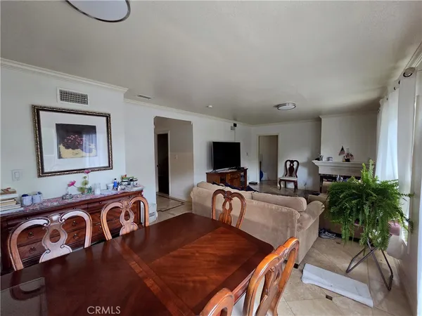 a living room with furniture a couch and a flat screen tv