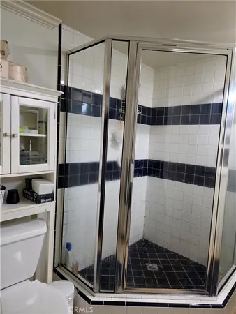 a bathroom with a shower and a mirror