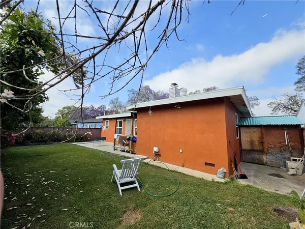 a backyard of a house with table and chairs
