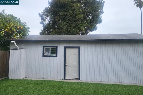 a view of backyard with cabin