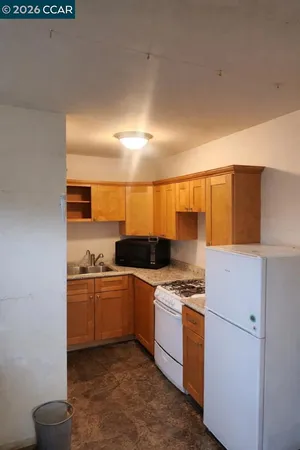a kitchen with granite countertop a stove and a sink