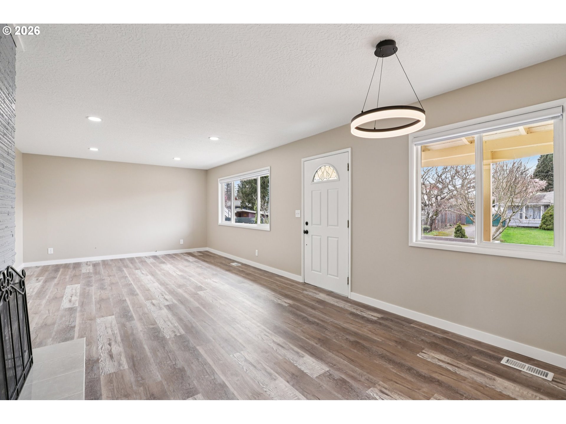 18021 Southeast Mill Court Portland, OR 97233 - Photo 6 of 36 a view of an empty room with a window and wooden floor