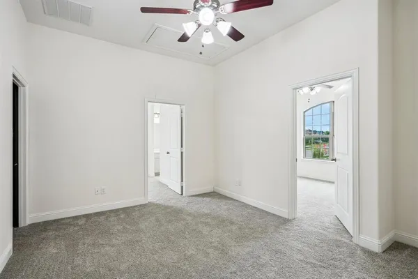 a view of a room with a ceiling fan