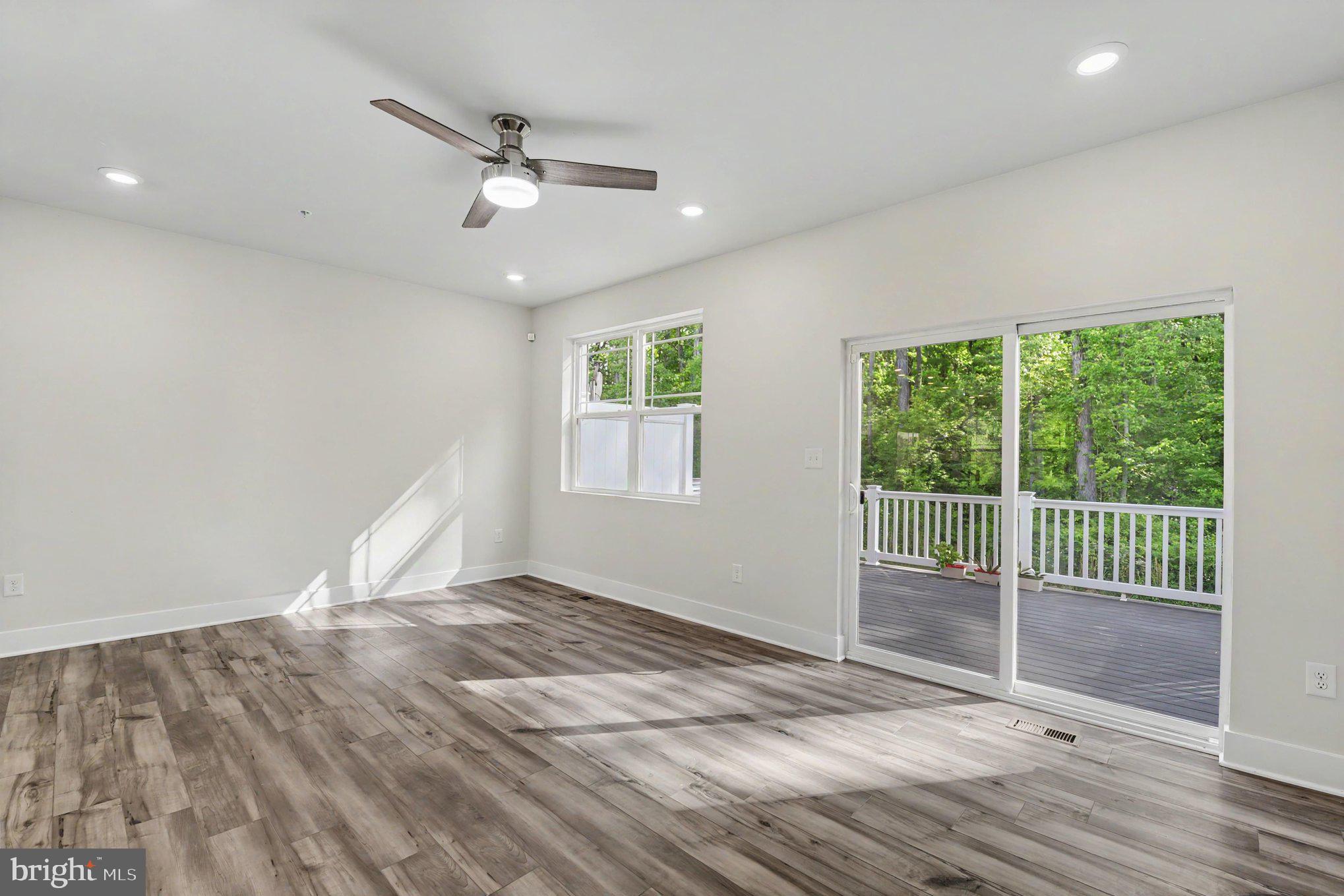238 Waterstone Road Essex, MD 21221 - Photo 18 of 39 an empty room with wooden floor and windows