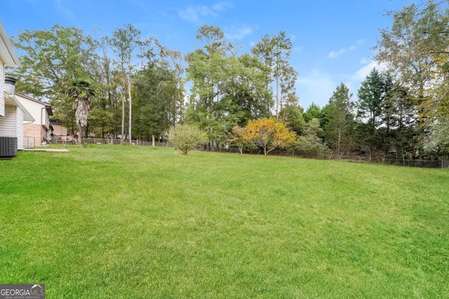a view of a grassy field with trees