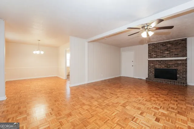a view of empty room with a fireplace and fan