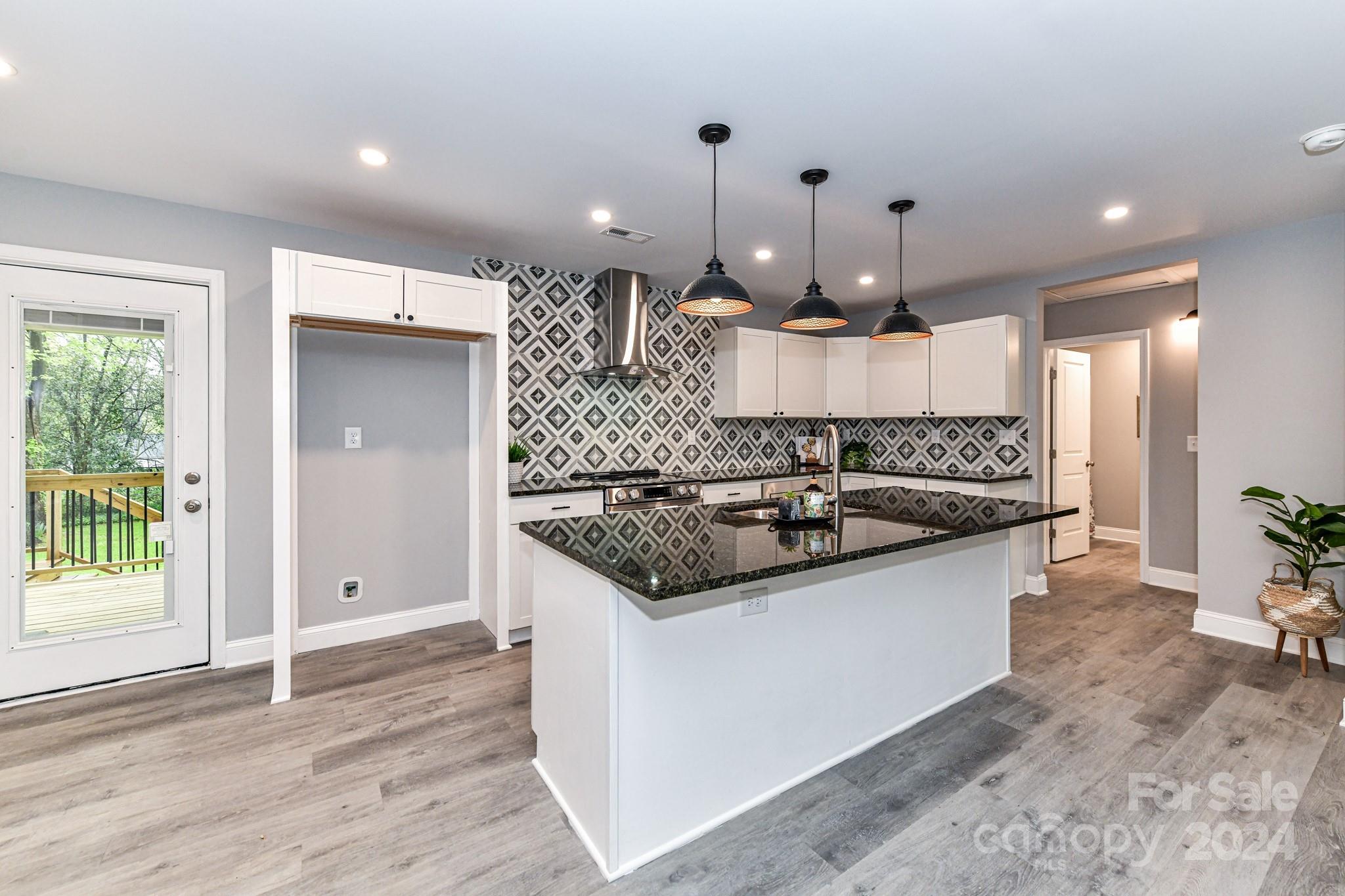 136 Spencer Avenue Northwest Concord, NC 28025 - Photo 11 of 43 a kitchen with stainless steel appliances granite countertop a sink and a stove