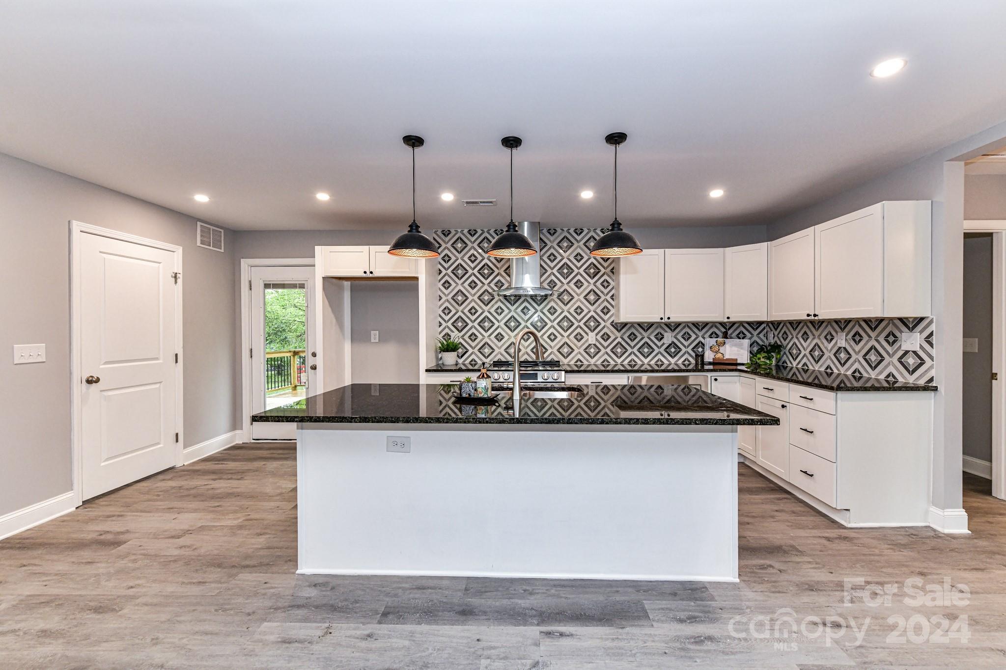 136 Spencer Avenue Northwest Concord, NC 28025 - Photo 12 of 43 a large kitchen with stainless steel appliances granite countertop a granite counter tops and a large window