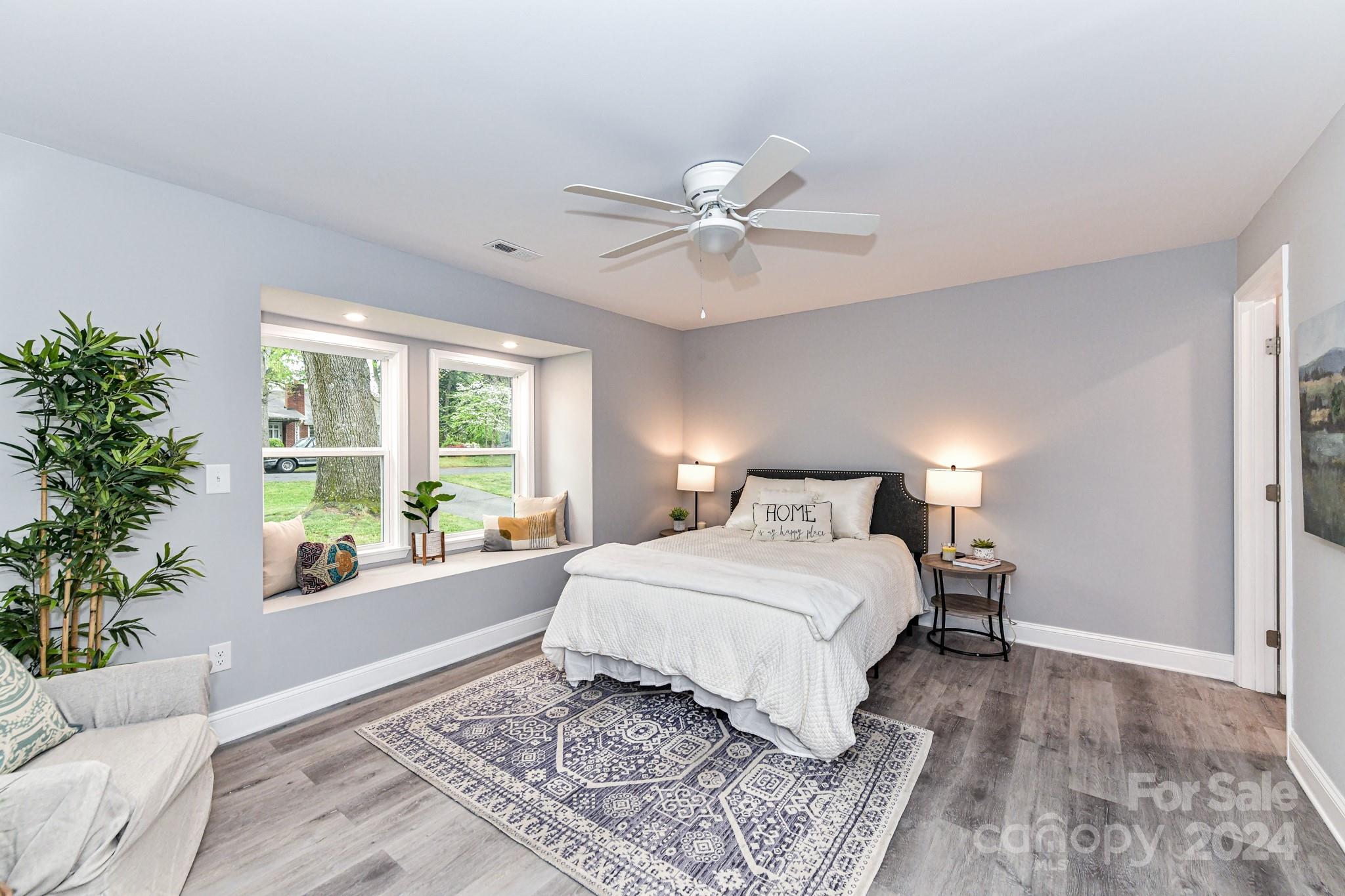 136 Spencer Avenue Northwest Concord, NC 28025 - Photo 17 of 43 a bedroom with a large bed plant and a window