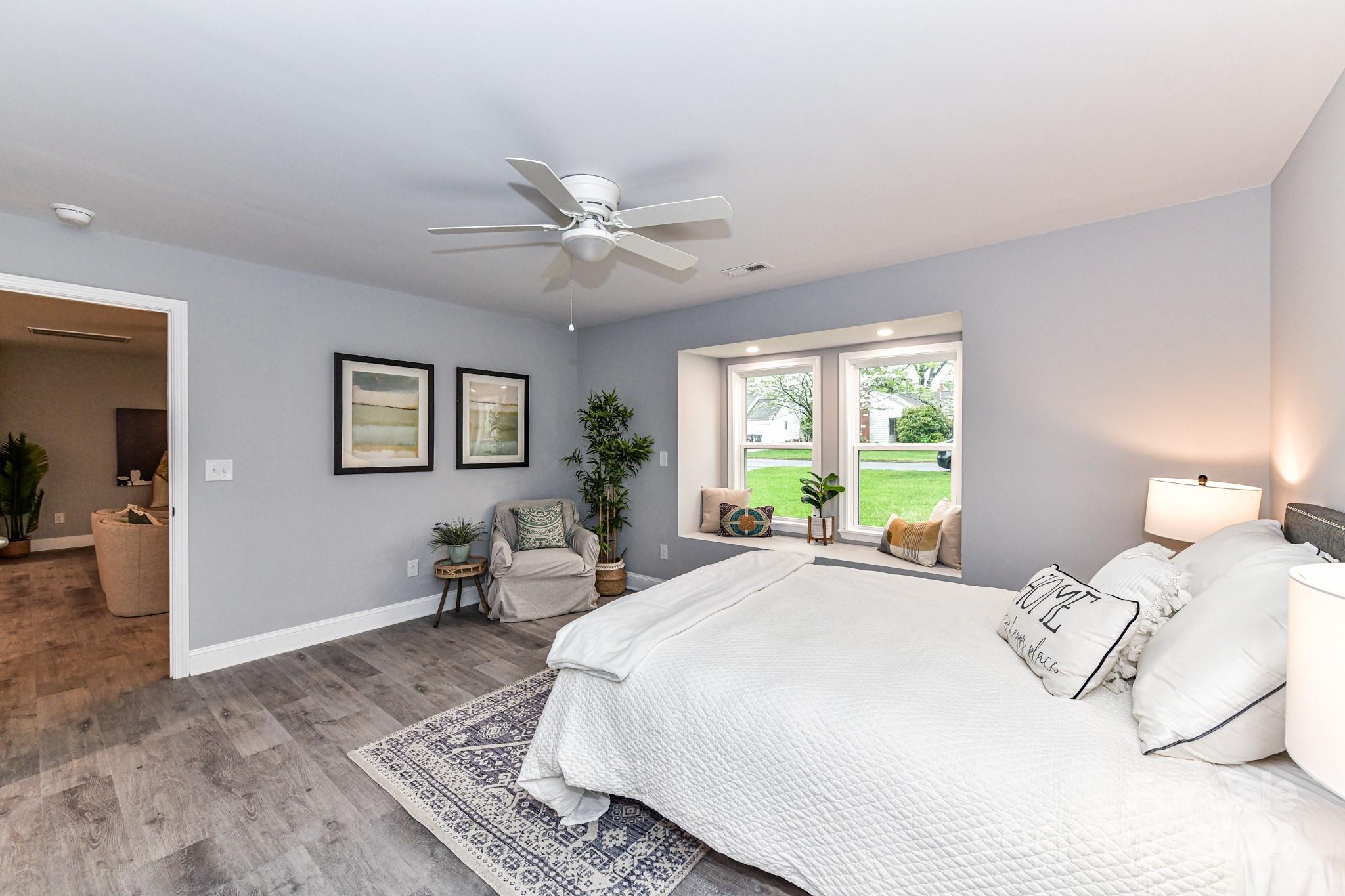 136 Spencer Avenue Northwest Concord, NC 28025 - Photo 19 of 43 a bedroom with a bed and wooden floor