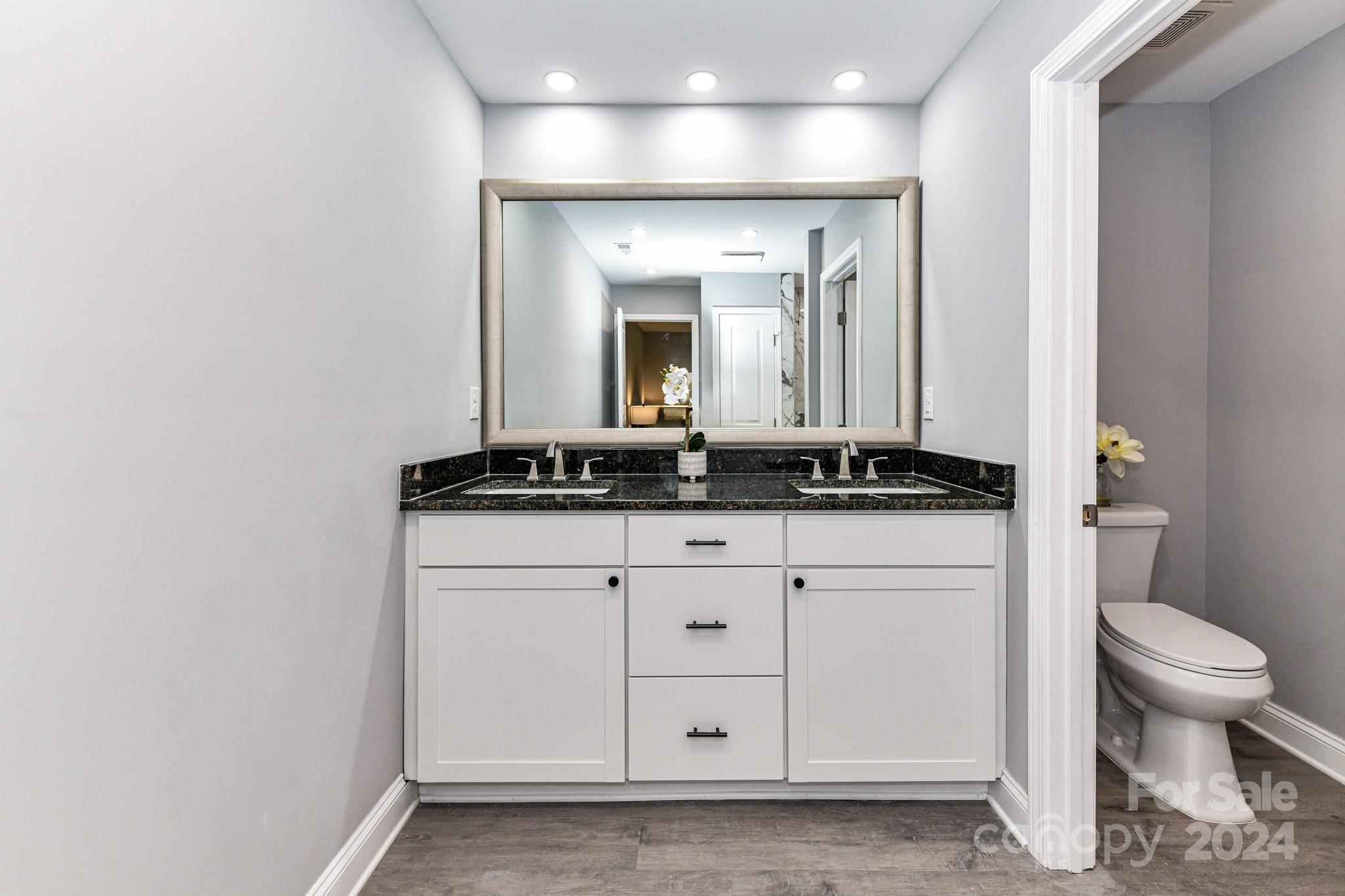 136 Spencer Avenue Northwest Concord, NC 28025 - Photo 20 of 43 a bathroom with a toilet sink and mirror
