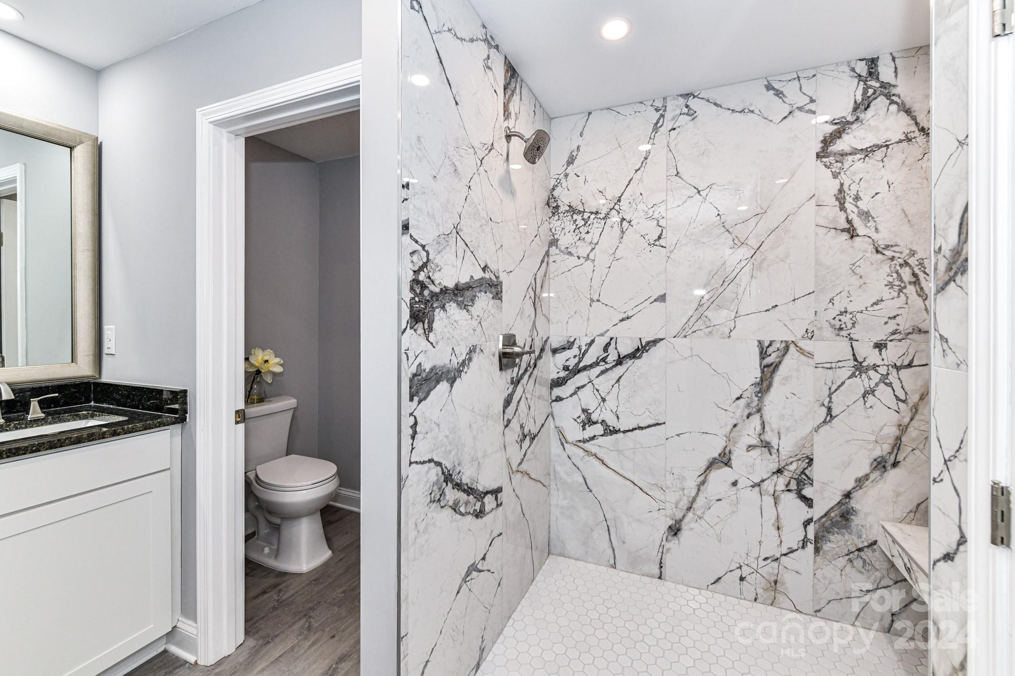 136 Spencer Avenue Northwest Concord, NC 28025 - Photo 21 of 43 a bathroom with a granite countertop sink toilet and shower