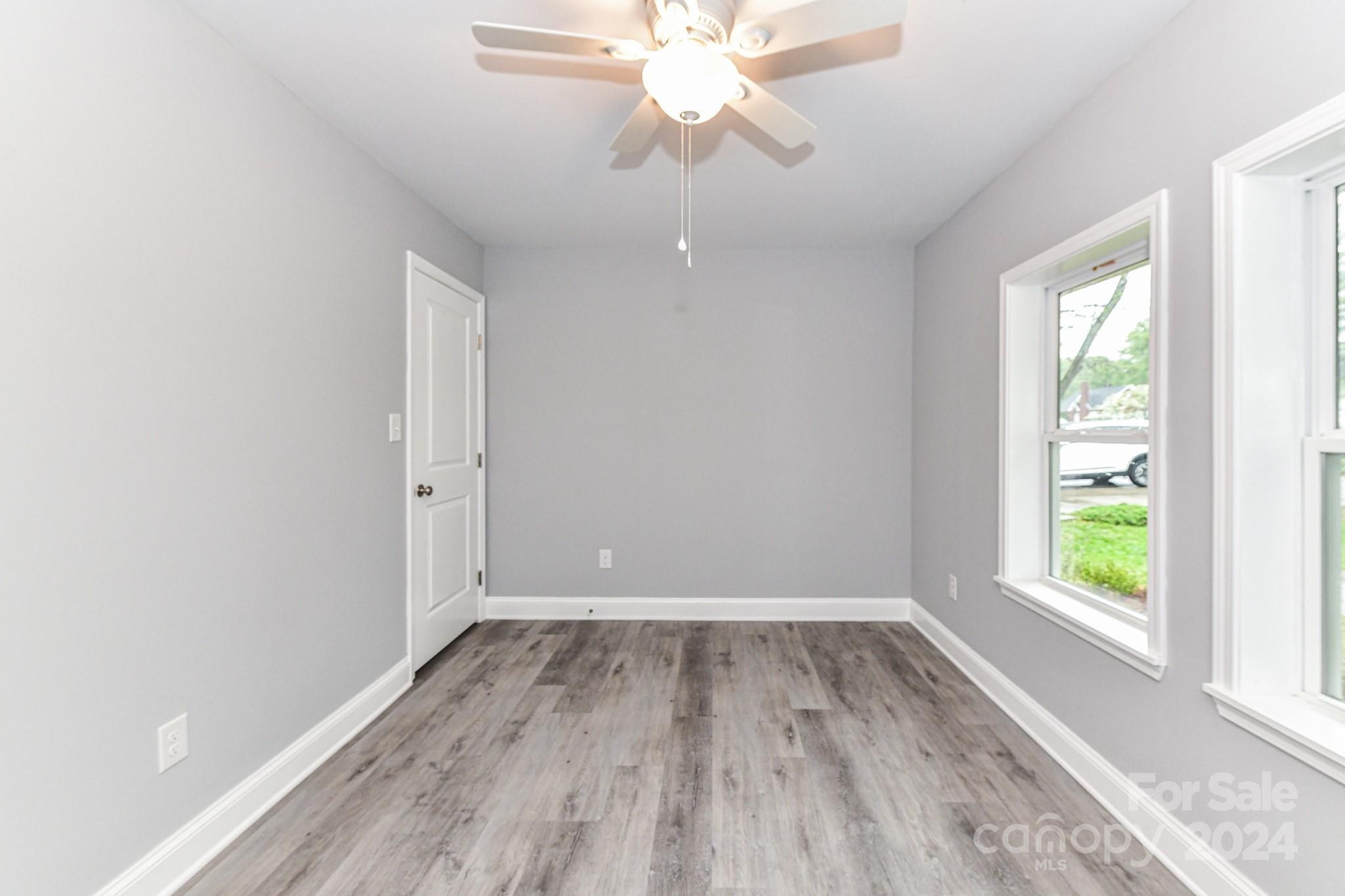 136 Spencer Avenue Northwest Concord, NC 28025 - Photo 25 of 43 wooden floor in an empty room with a window