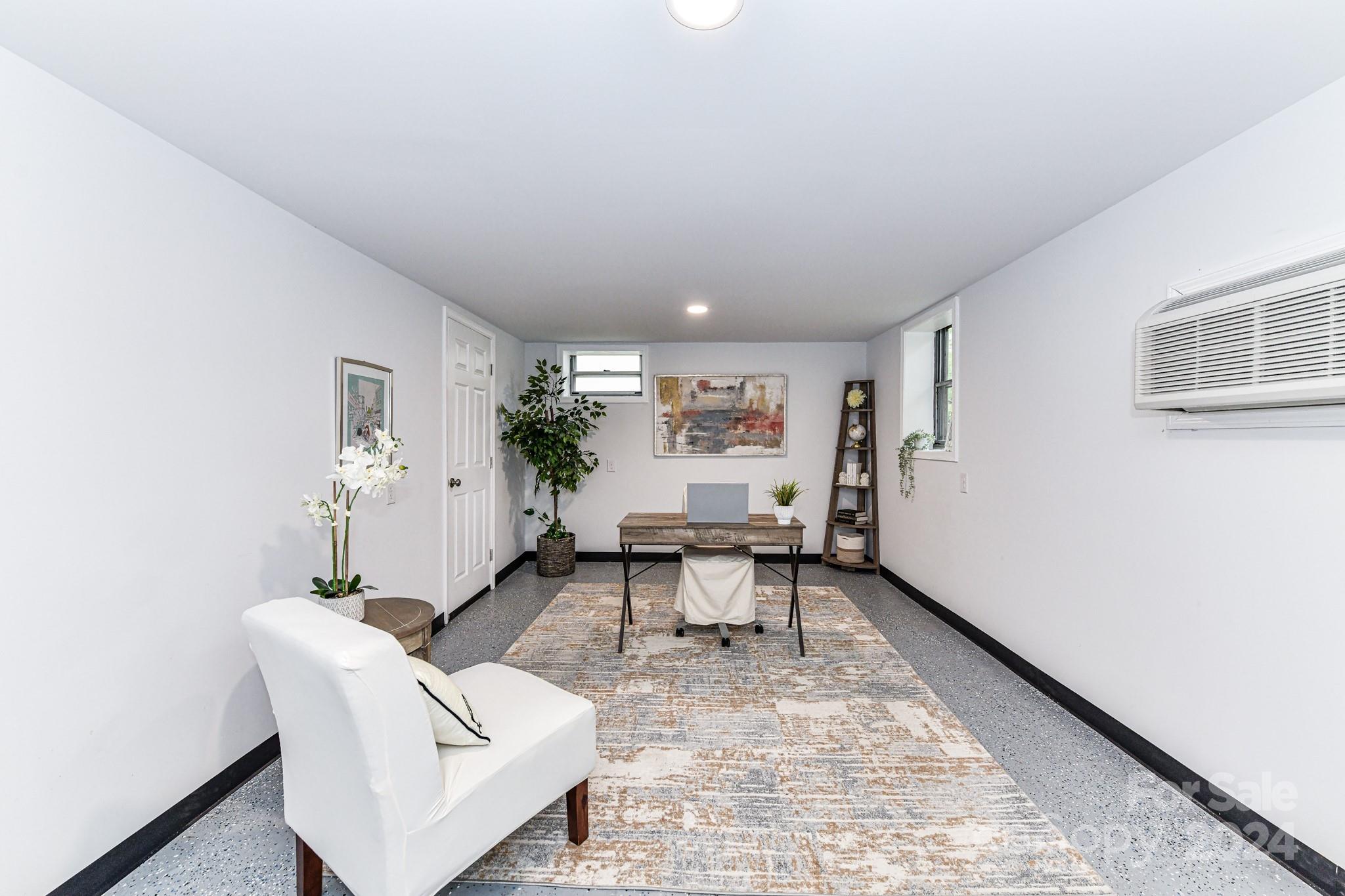 136 Spencer Avenue Northwest Concord, NC 28025 - Photo 28 of 43 a living room with furniture and a table