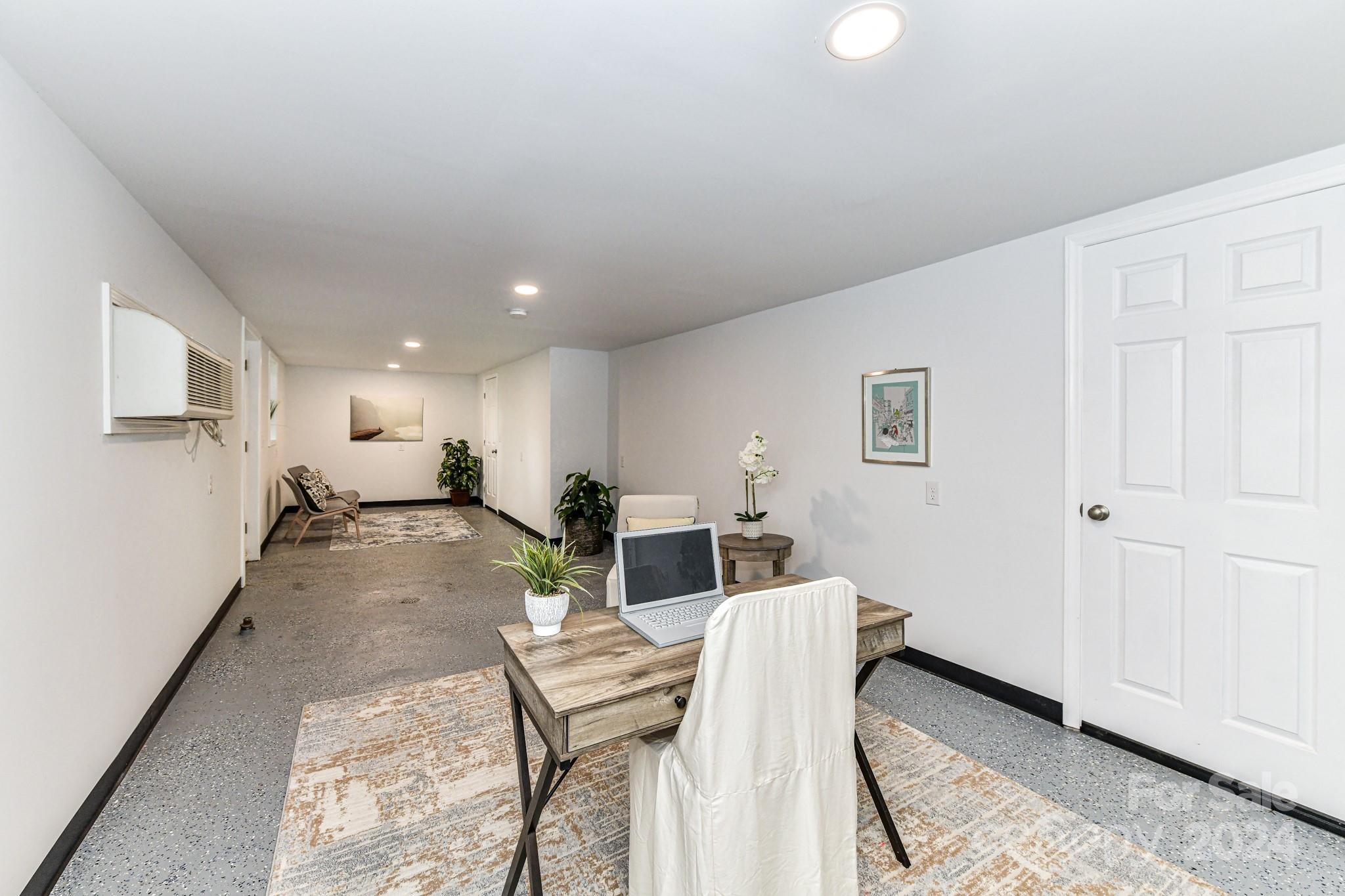 136 Spencer Avenue Northwest Concord, NC 28025 - Photo 29 of 43 a living room with furniture and a wooden floor