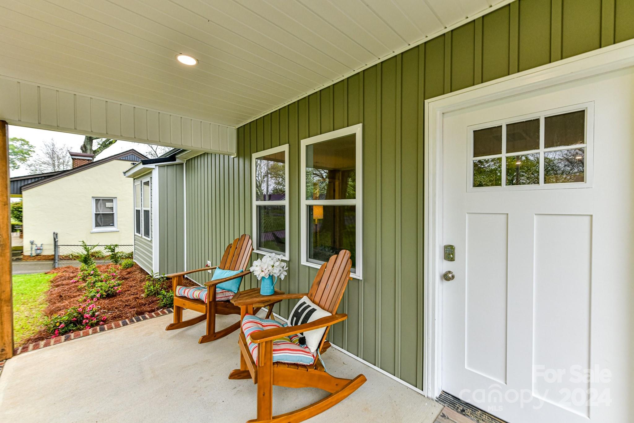 136 Spencer Avenue Northwest Concord, NC 28025 - Photo 3 of 43 a backyard of a house with table and chairs