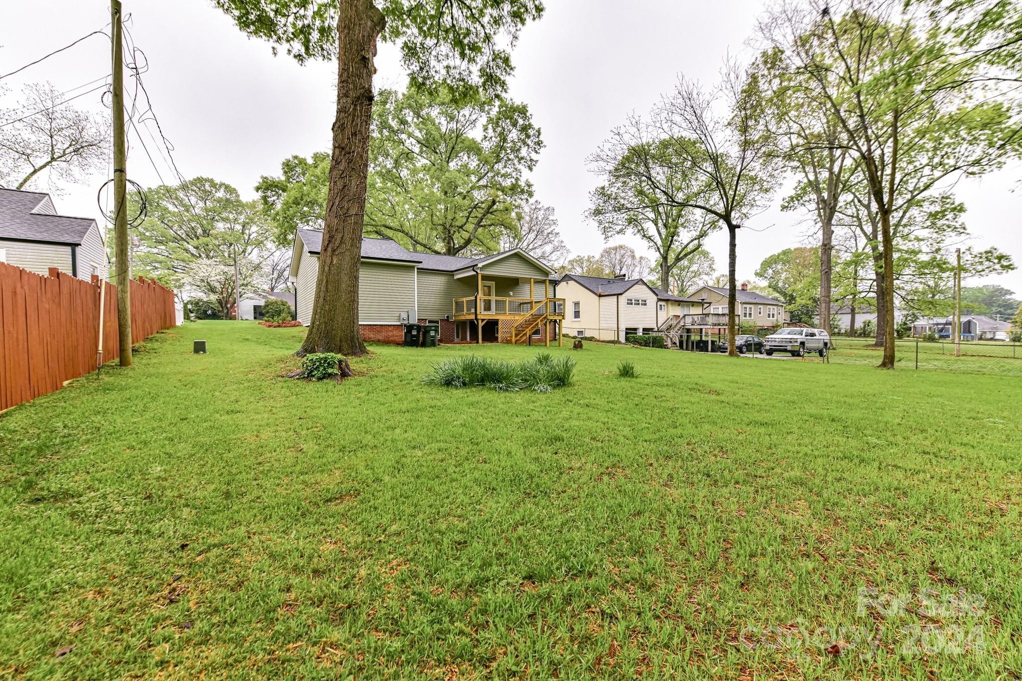 136 Spencer Avenue Northwest Concord, NC 28025 - Photo 38 of 43 a view of a house with a big yard and large trees