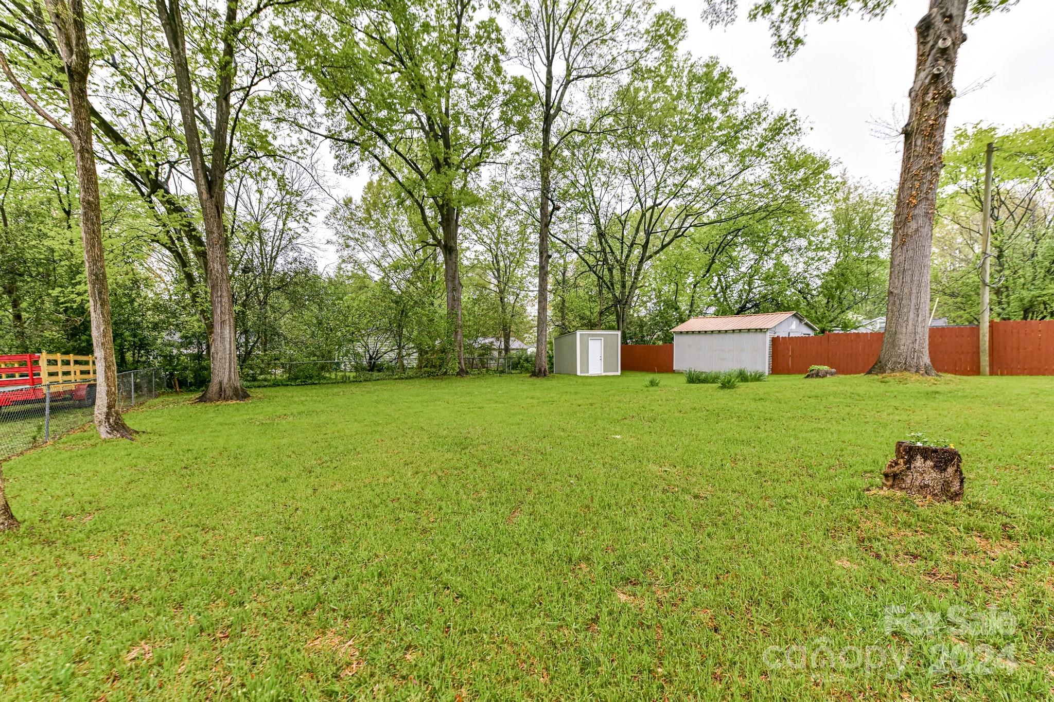 136 Spencer Avenue Northwest Concord, NC 28025 - Photo 40 of 43 a backyard of a house with lots of green space