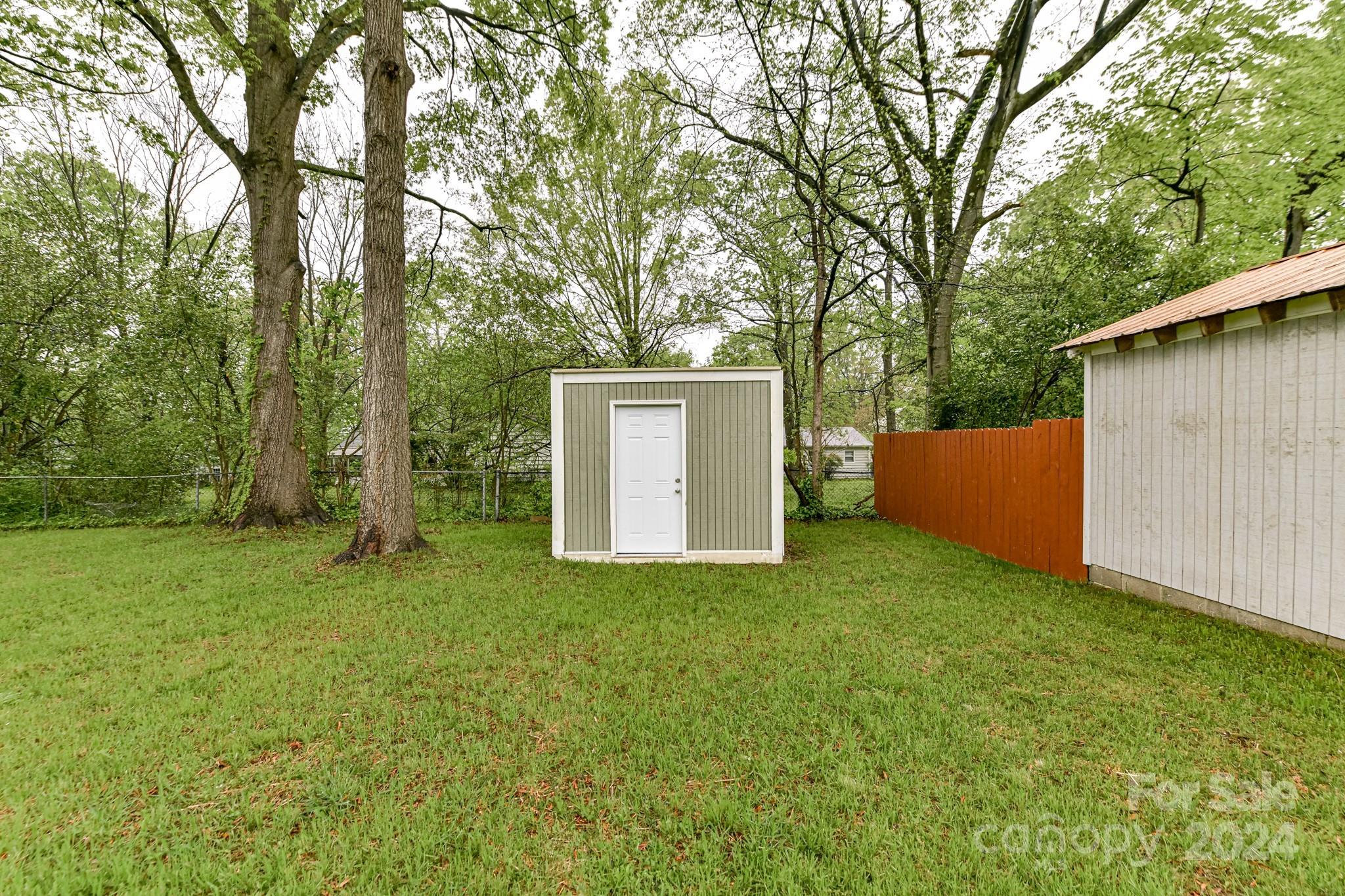 136 Spencer Avenue Northwest Concord, NC 28025 - Photo 41 of 43 a backyard of a house with lots of green space