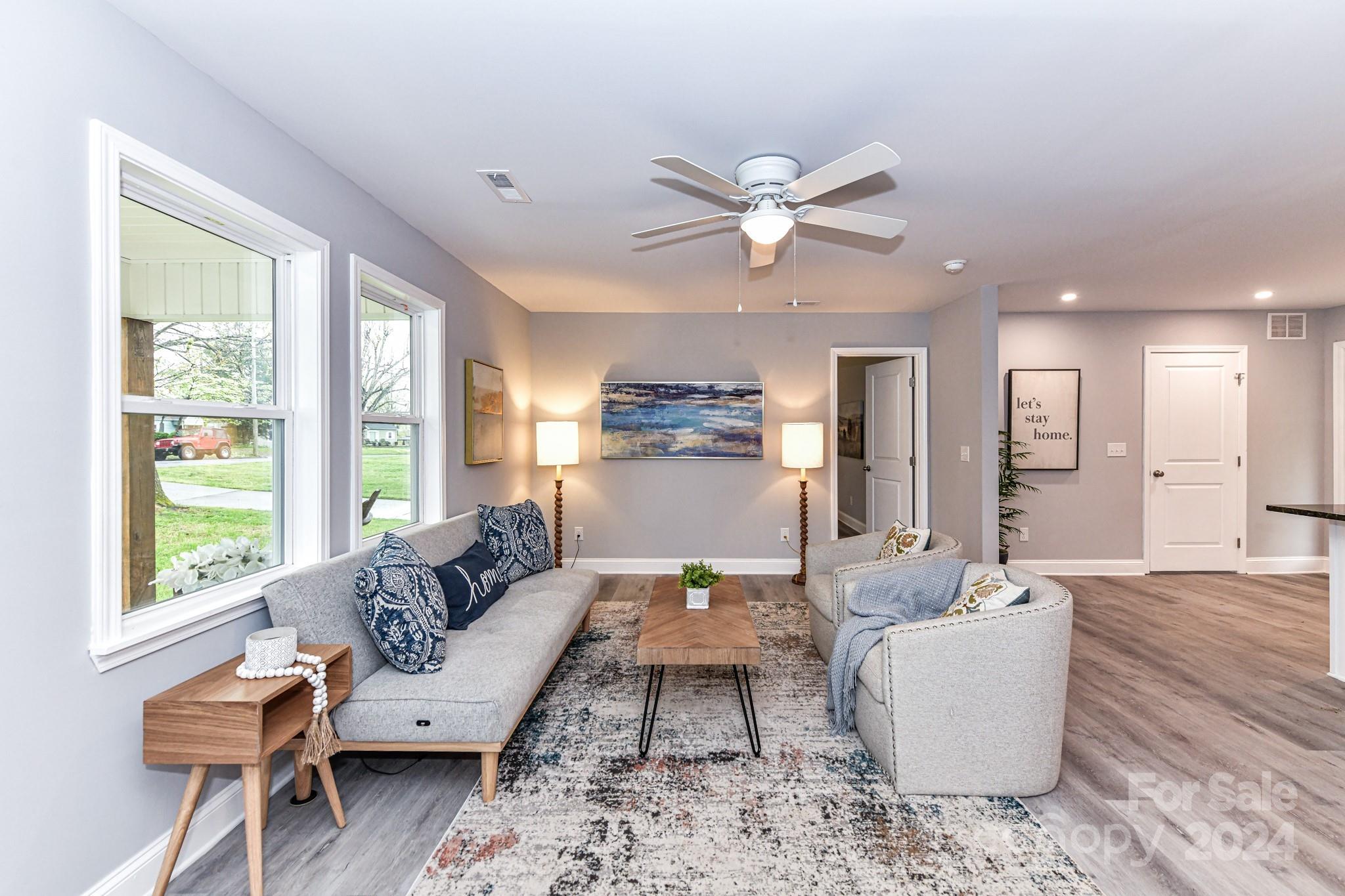 136 Spencer Avenue Northwest Concord, NC 28025 - Photo 5 of 43 a living room with furniture and a large window