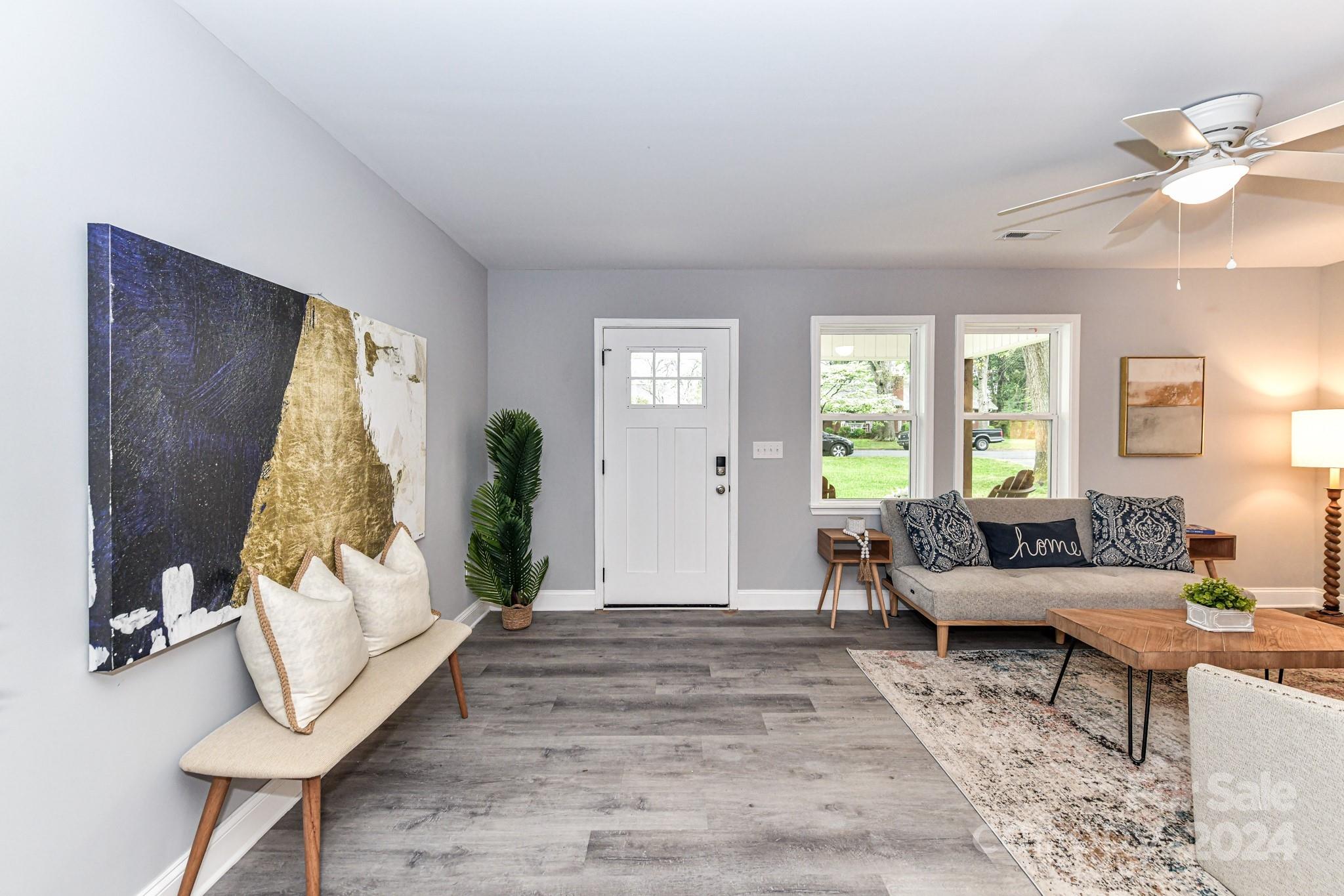 136 Spencer Avenue Northwest Concord, NC 28025 - Photo 7 of 43 a living room with furniture and a large window