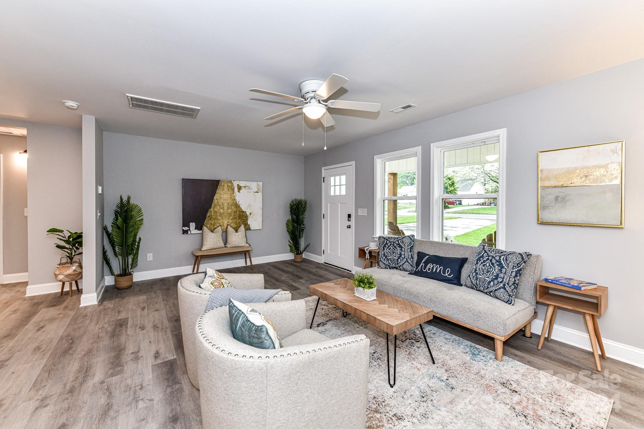 136 Spencer Avenue Northwest Concord, NC 28025 - Photo 8 of 43 a living room with furniture and a large window