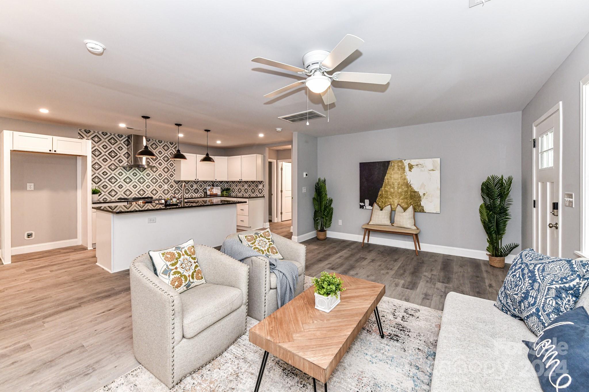 136 Spencer Avenue Northwest Concord, NC 28025 - Photo 10 of 43 a living room with furniture and kitchen view