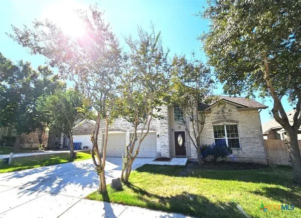 a view of a yard with furniture and a tree