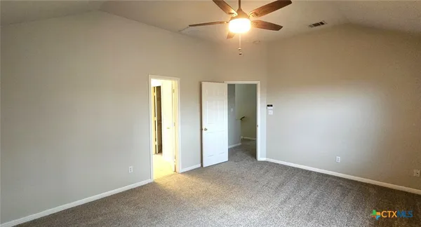an empty room with a fan and a fan