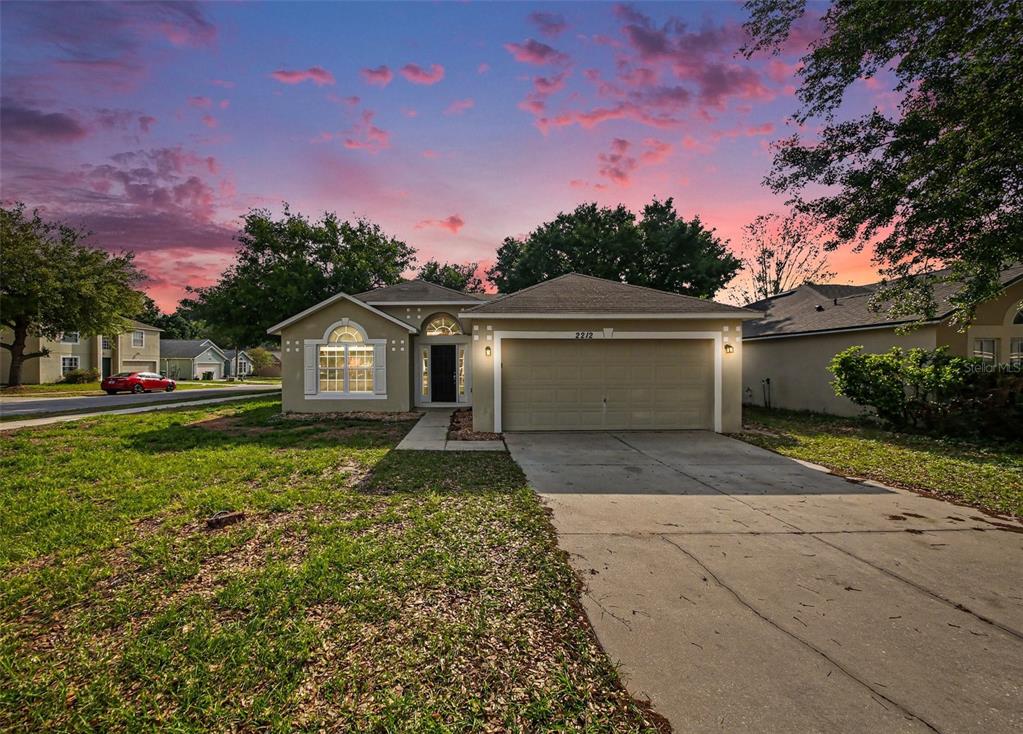2212 Nicollett Way Leesburg, FL 34748 - Photo 1 of 26 a front view of a house with garden