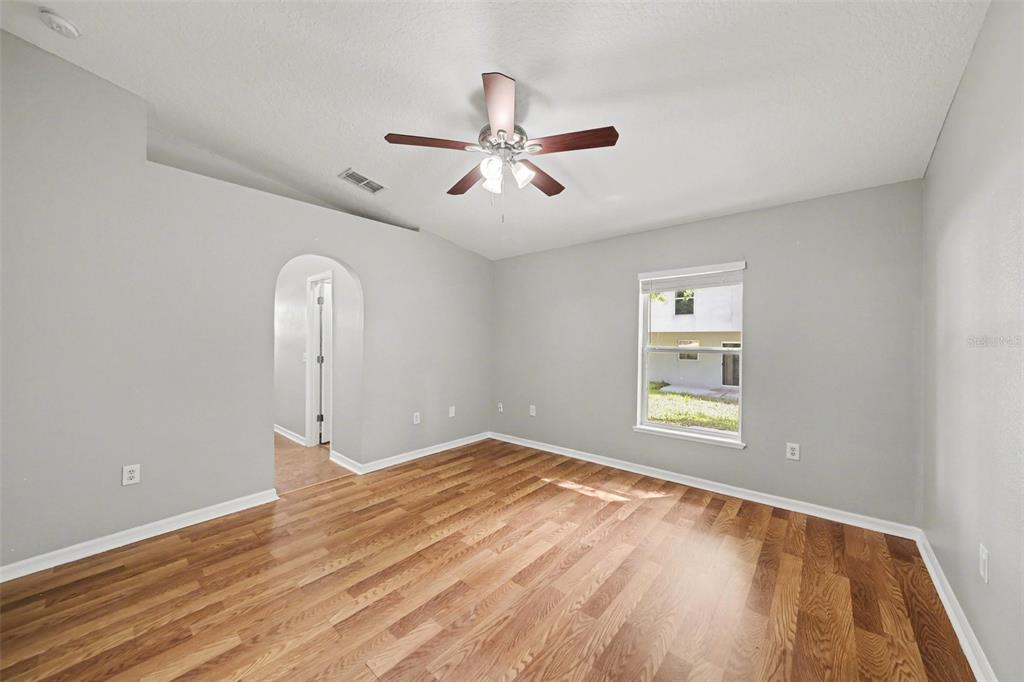 2212 Nicollett Way Leesburg, FL 34748 - Photo 13 of 26 wooden floor in an empty room with a window