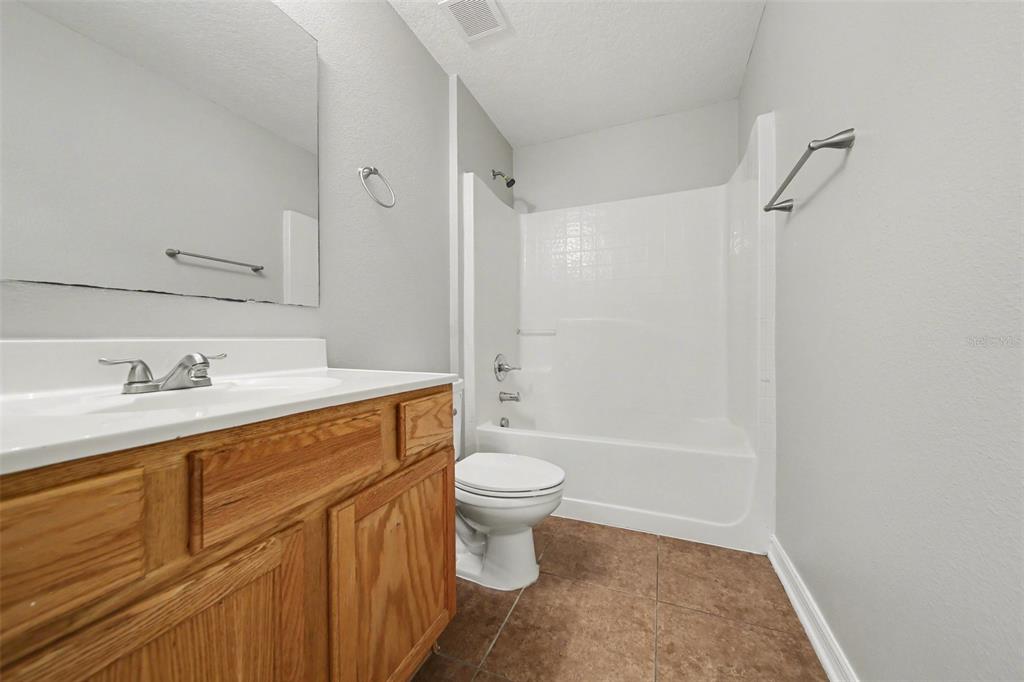 2212 Nicollett Way Leesburg, FL 34748 - Photo 18 of 26 a bathroom with a sink a toilet and shower