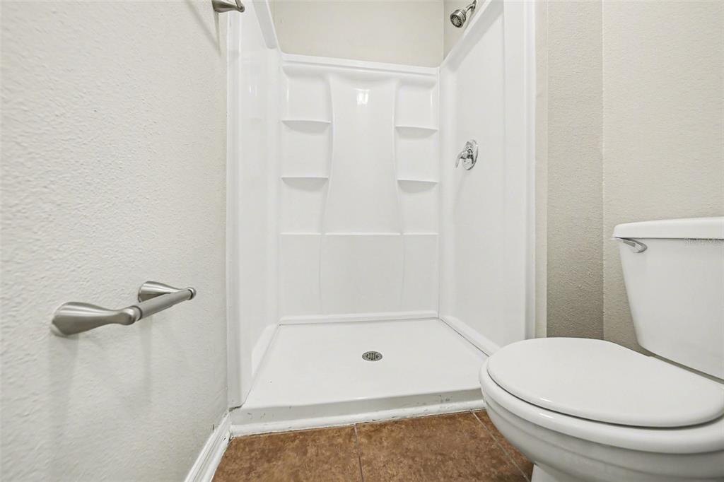 2212 Nicollett Way Leesburg, FL 34748 - Photo 20 of 26 a bathroom with a toilet and a shower