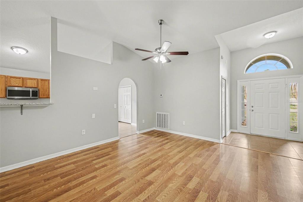 2212 Nicollett Way Leesburg, FL 34748 - Photo 7 of 26 wooden floor in an empty room with a window
