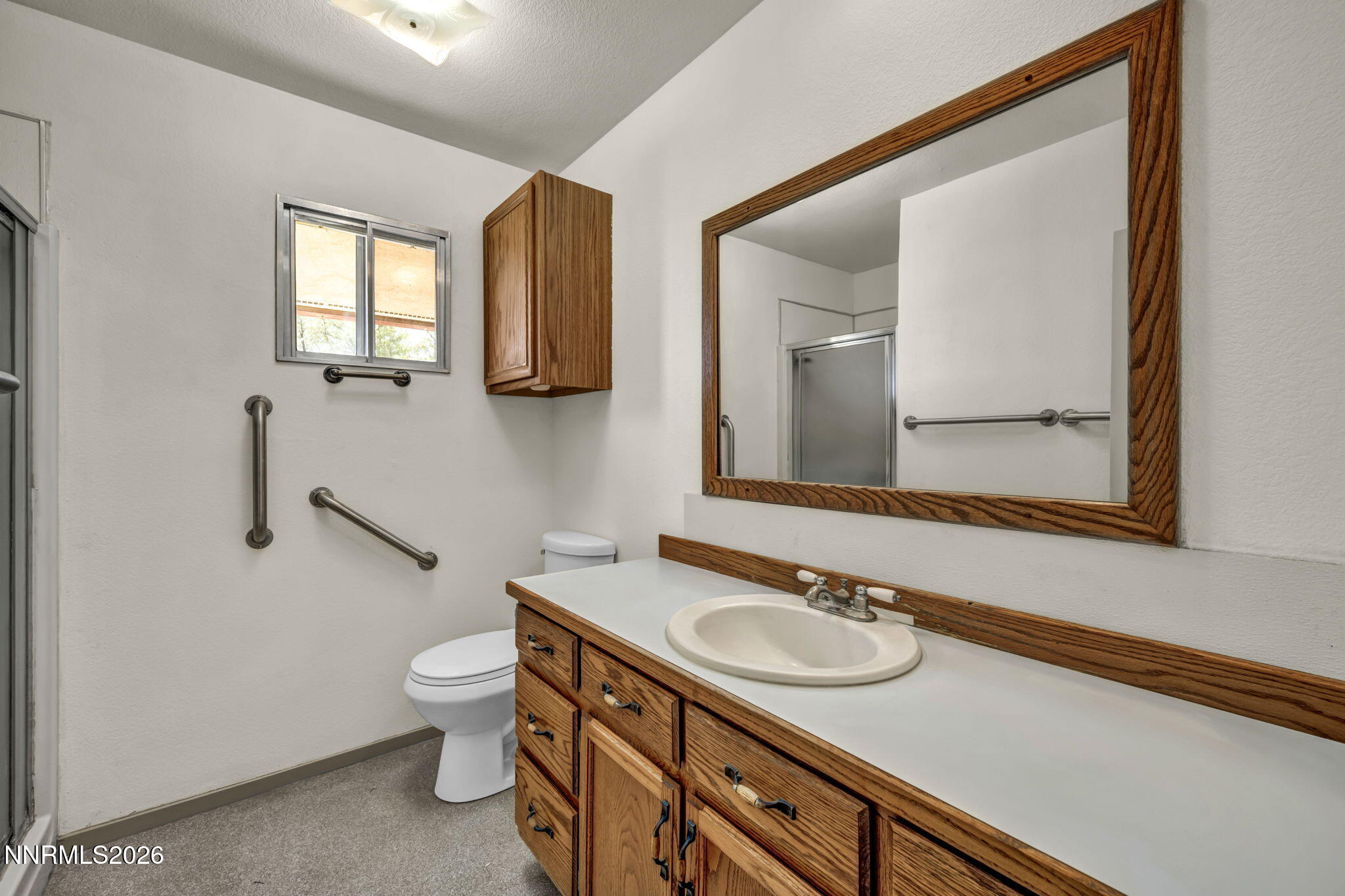 5250 Stillwater Road Fallon, NV 89406 - Photo 24 of 53 a bathroom with a sink a toilet and a mirror