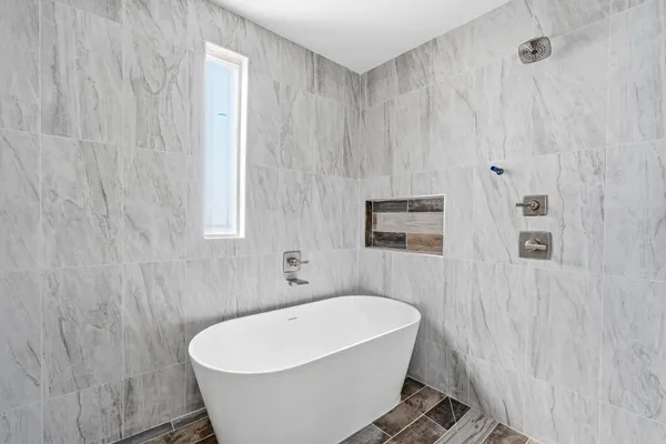 a white bath tub sitting in a bathroom