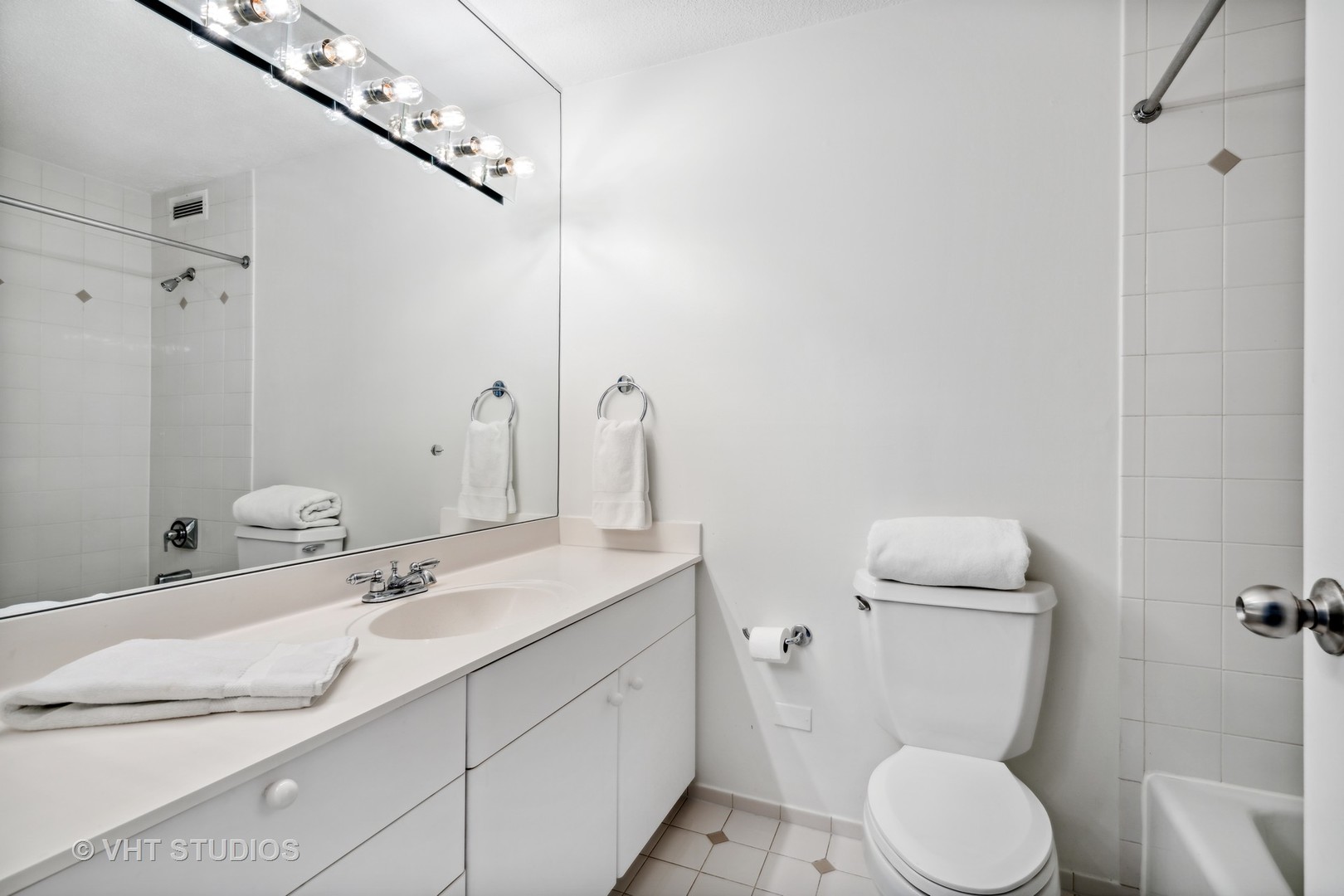 1313 North Ritchie Court, Unit 1304 Chicago, IL 60610 - Photo 12 of 20 a bathroom with a granite countertop toilet sink and mirror