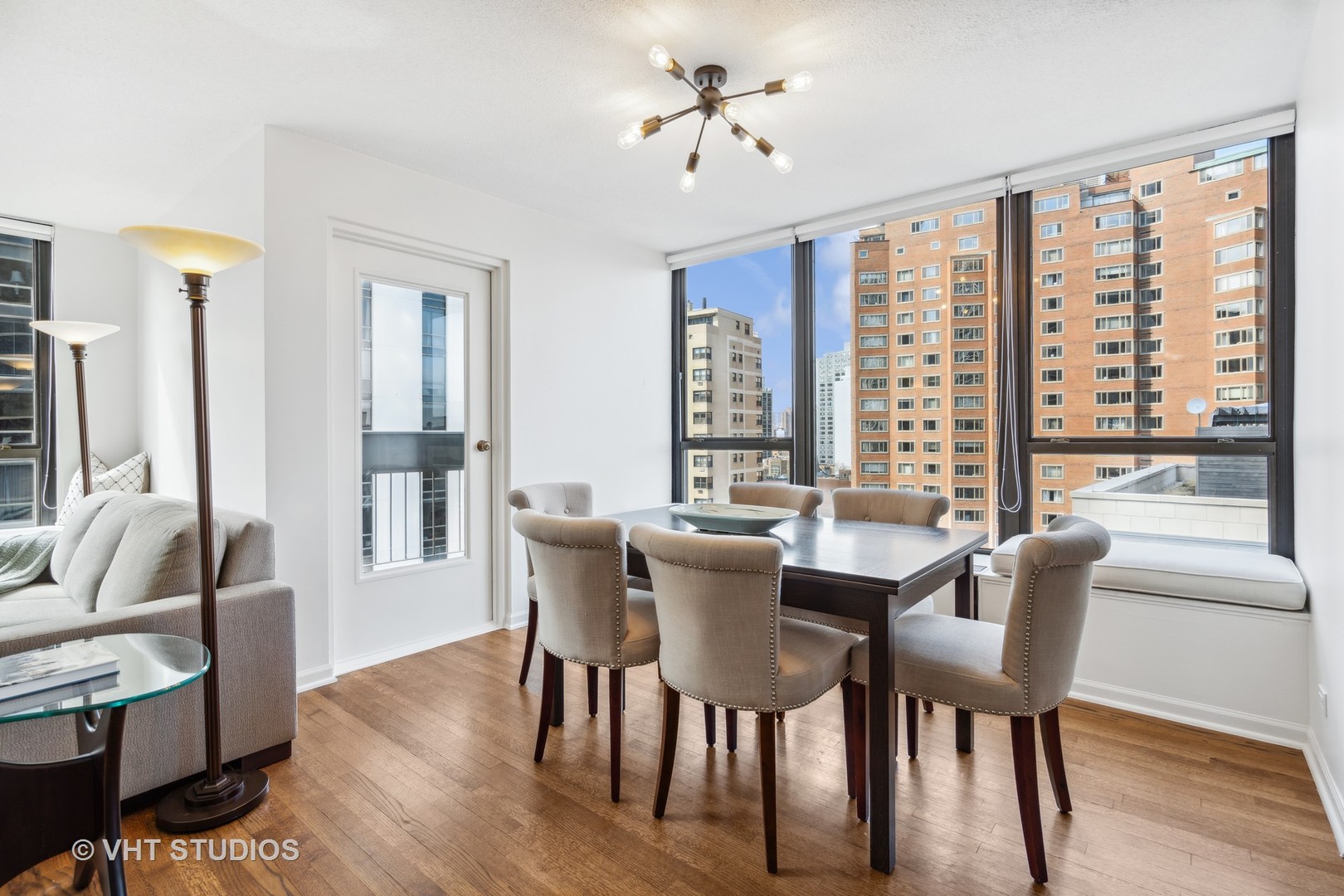 1313 North Ritchie Court, Unit 1304 Chicago, IL 60610 - Photo 4 of 20 a view of a dining room with furniture window and wooden floor