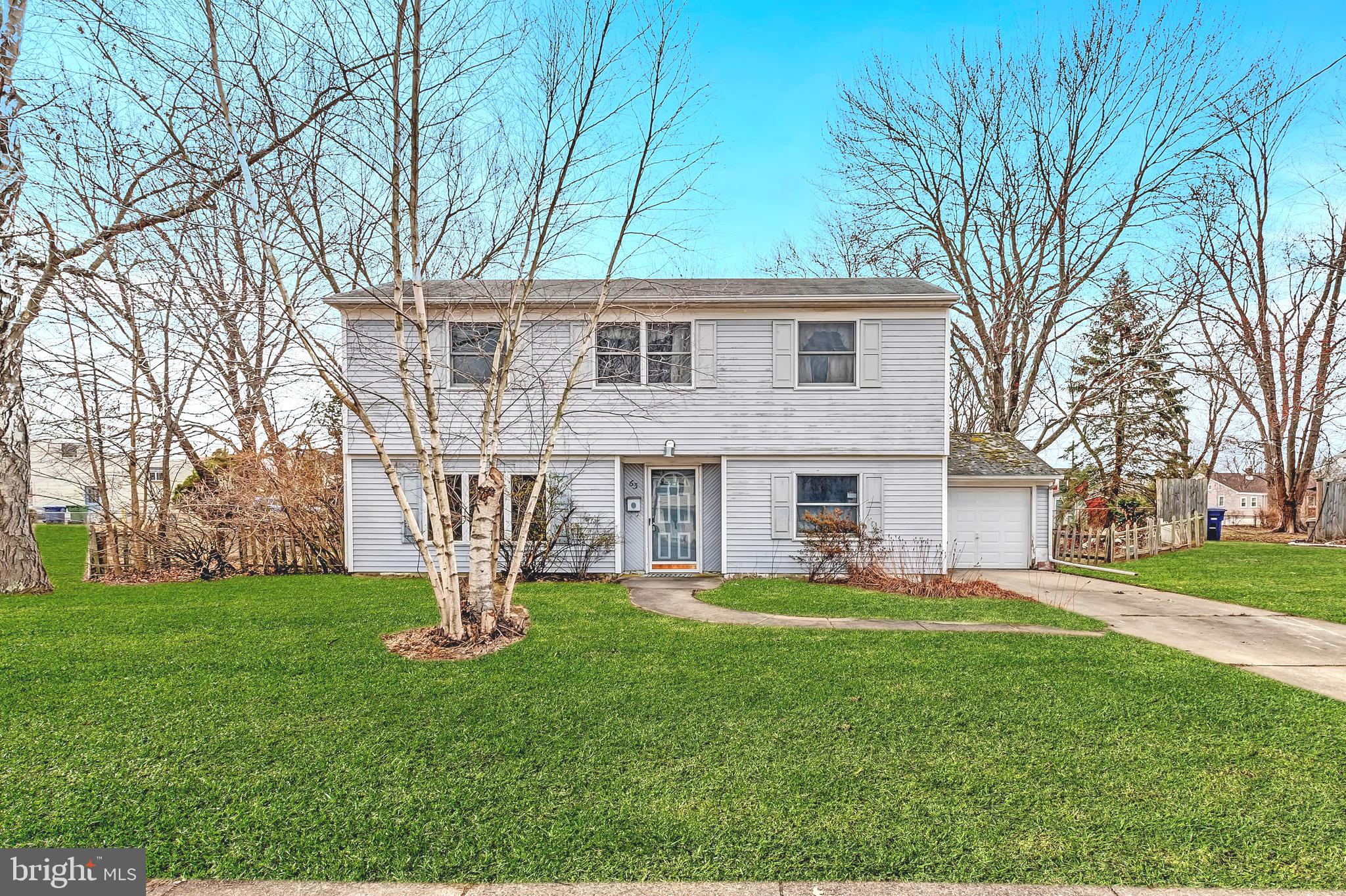 63 Baker Boulevard Marlton, NJ 08053 - Photo 2 of 10 a front view of a house with garden and trees