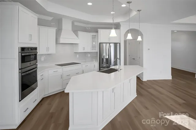 a kitchen with a sink stove and cabinets