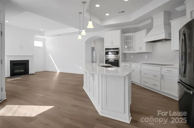 a kitchen with stainless steel appliances a stove refrigerator sink and microwave