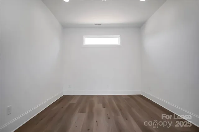 a view of an empty room and wooden floor